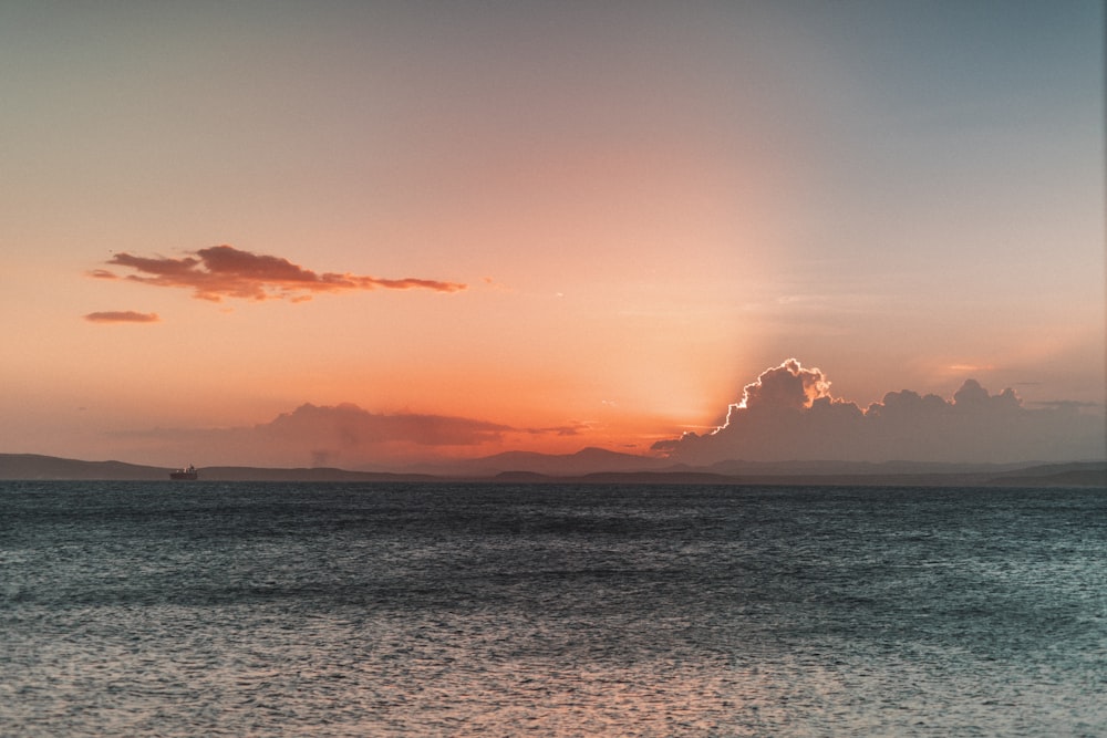 body of water during sunset