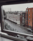 View from the window showing a quiet Oxford street lined with historic buildings.