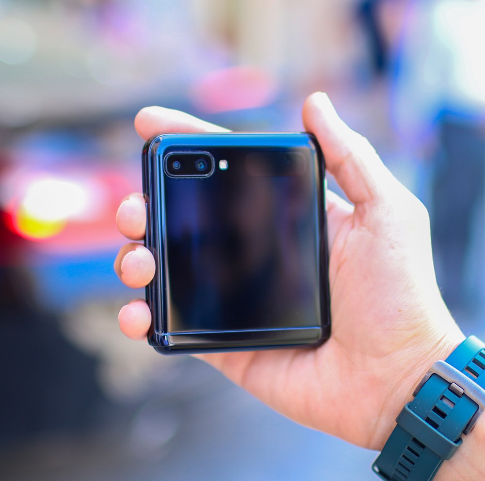 person holding black iphone 4