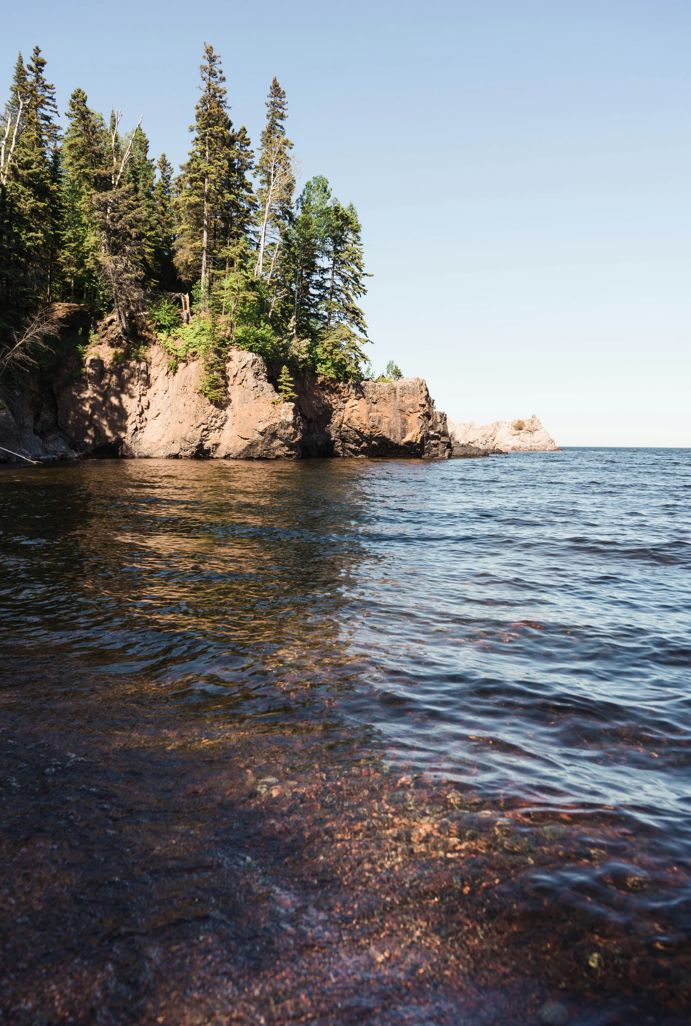 brown rock formation on sea during daytime