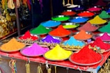 Close-up of vibrant kumkum powders arranged in traditional brass bowls.