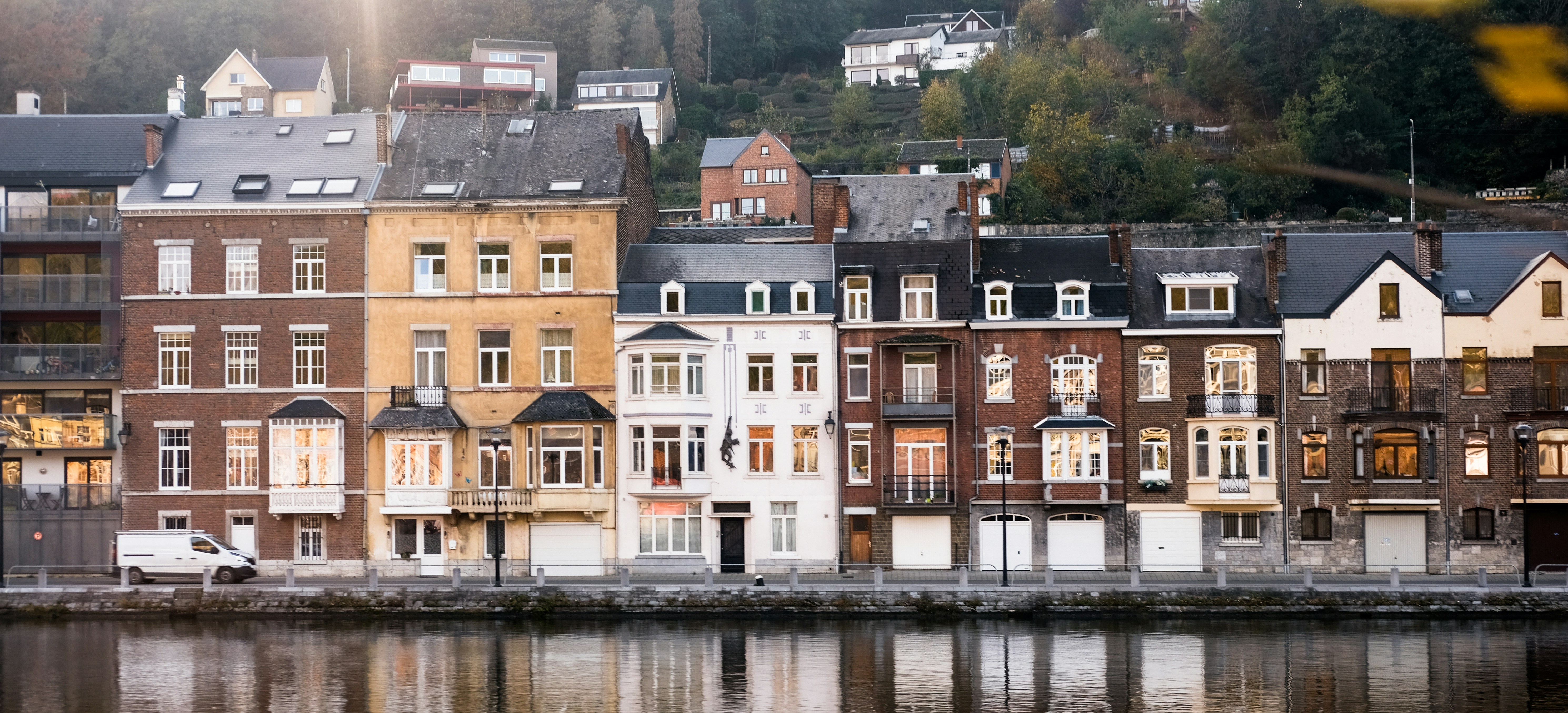 brown and white concrete building beside body of water during daytime
