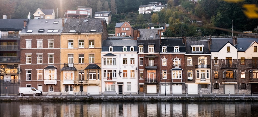 brown and white concrete building beside body of water during daytime