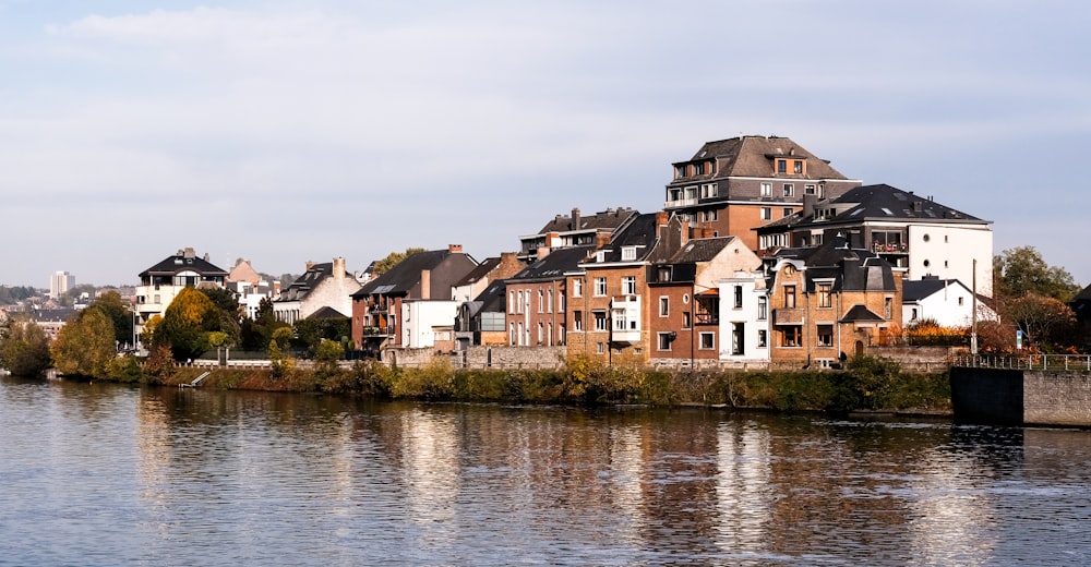 Casas de hormigón marrón y blanco junto al río durante el día