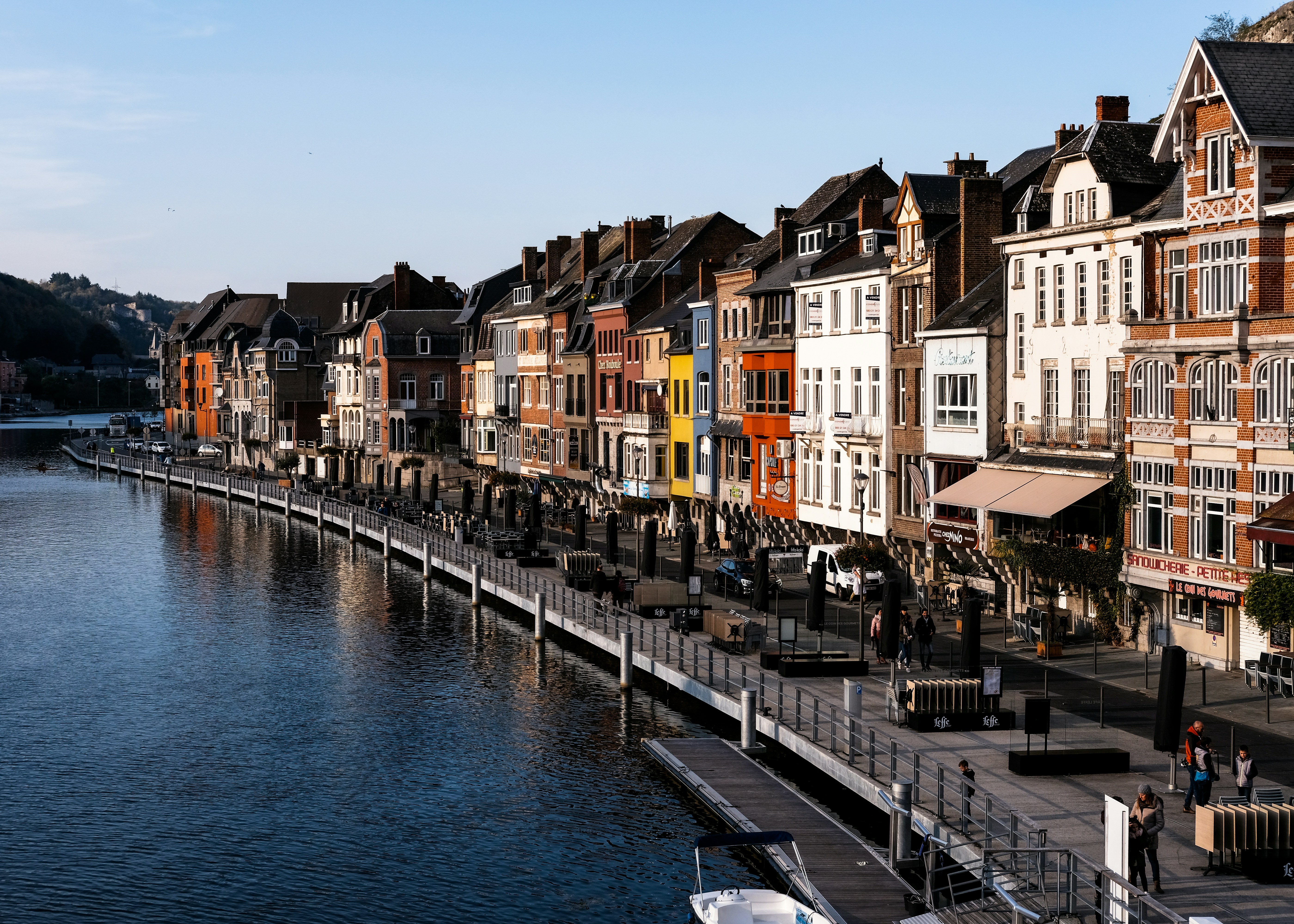 Side of a european city with colorful brick houses next to the river.
