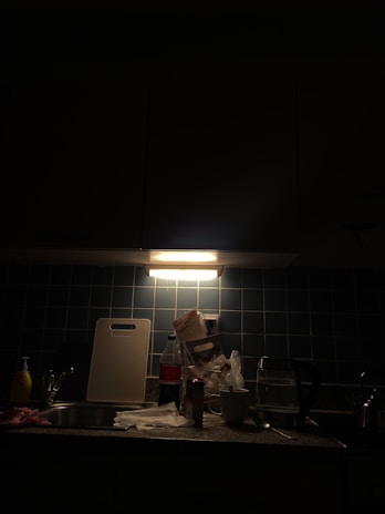 Close-up of a palicom LED tube light installed under kitchen cabinets, highlighting the countertop.