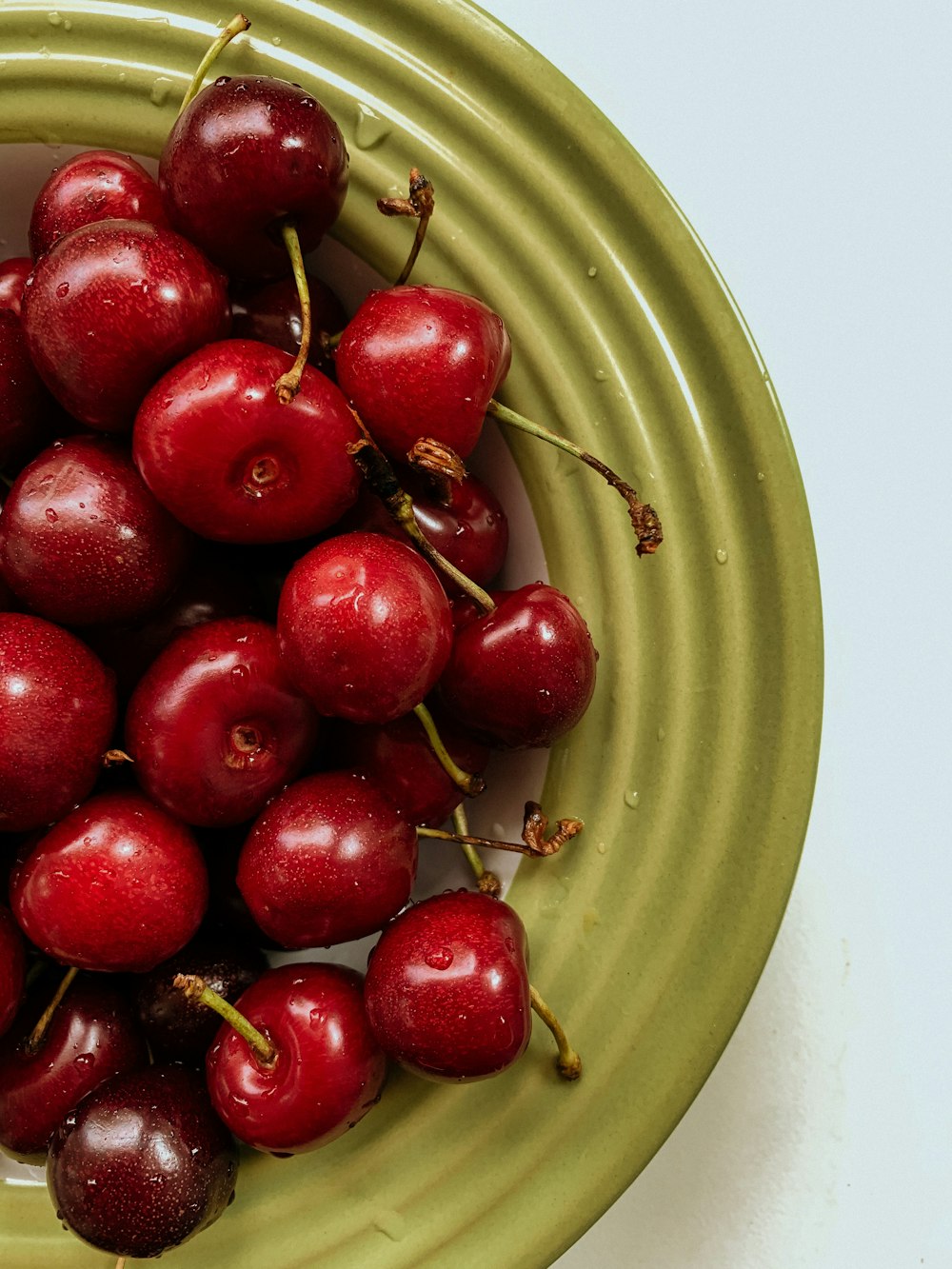 red round fruits on green round plate