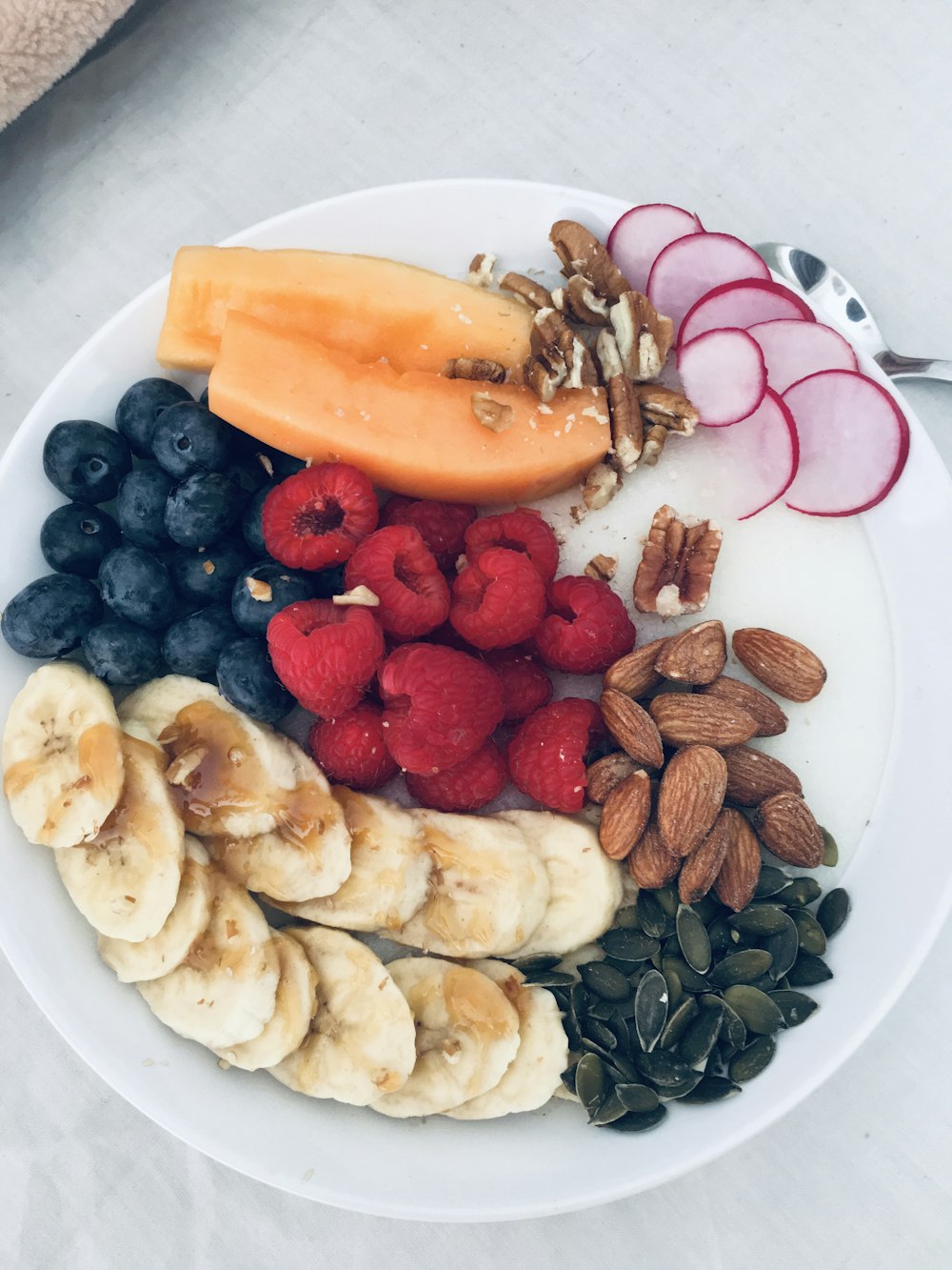 sliced fruits on white ceramic plate