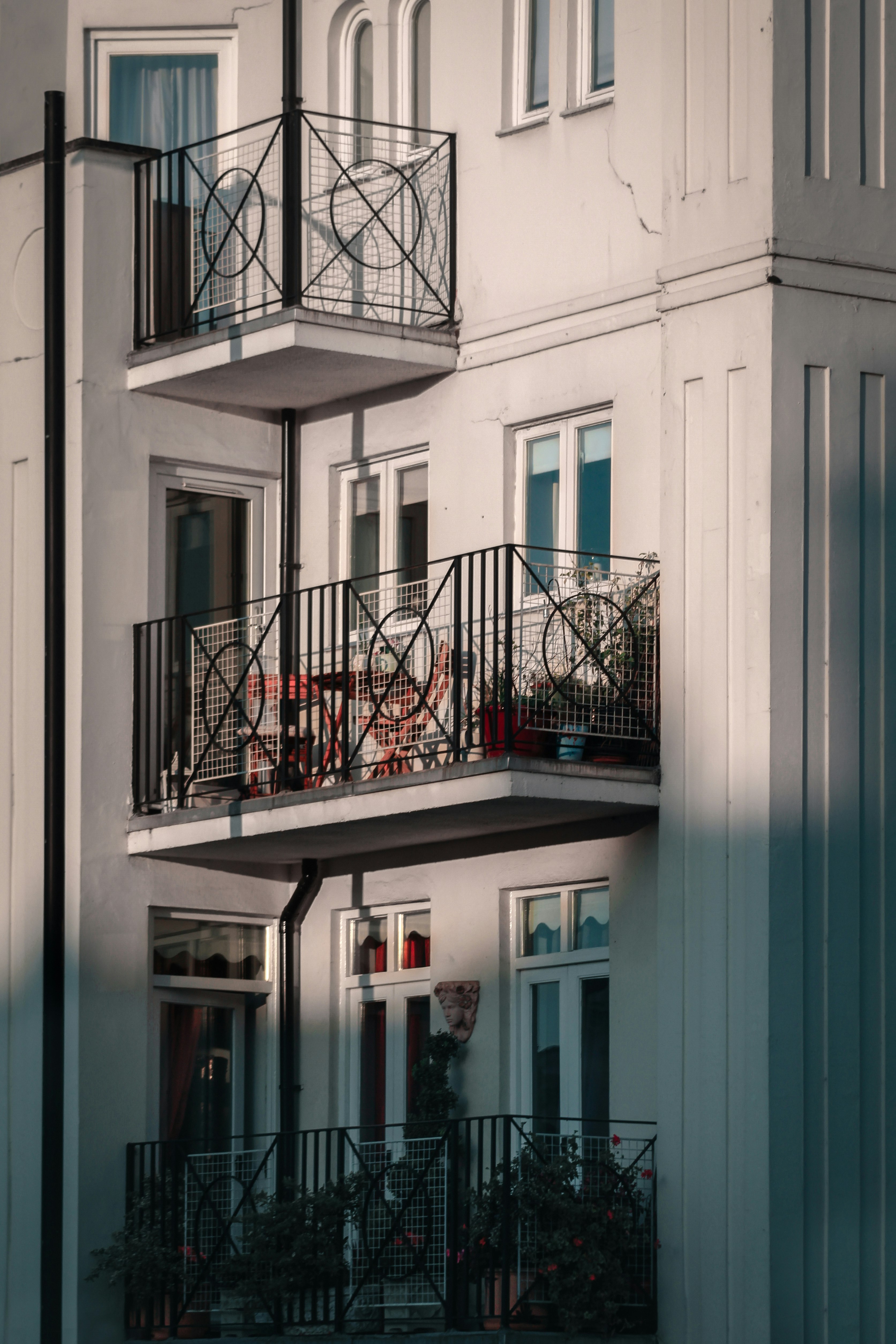 white concrete building with black metal railings