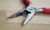 red and silver scissors on brown wooden table