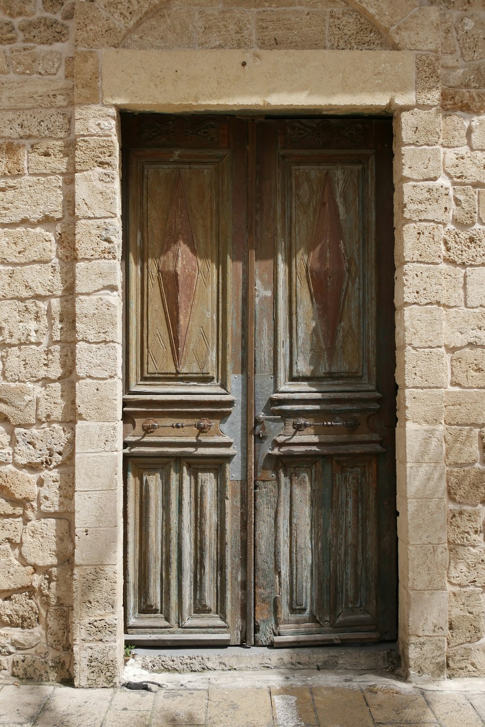 brown wooden door on white concrete wall