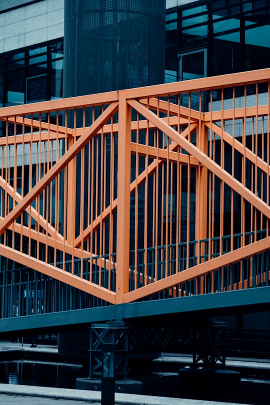 orange metal railings near building during daytime in Stuttgart Germany
