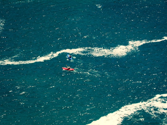 person surfing on ocean waves during daytime in Knysna South Africa
