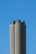 Three tall, cylindrical cement silos stand against a clear blue sky. The structures are slightly weathered, with darker top sections.