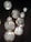 Several intricately designed, spherical pendant lights hang against a dark background. The lights feature detailed patterns with a mix of floral and geometric motifs, casting a warm, diffused glow.