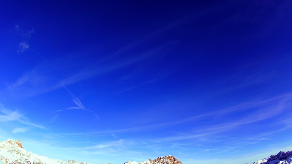 blue sky over green grass field