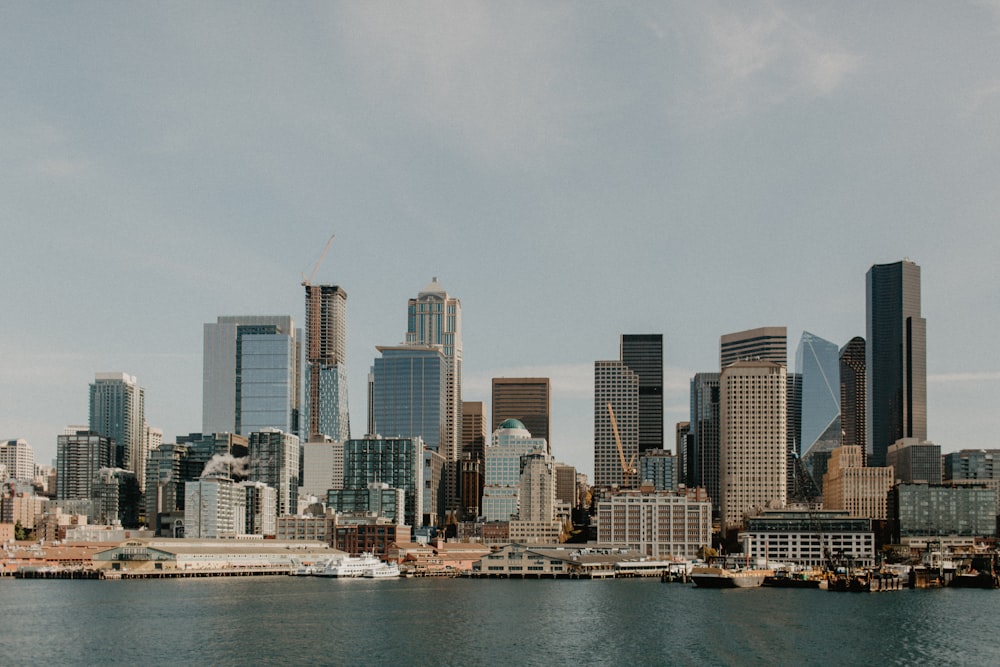 city skyline across body of water during daytime