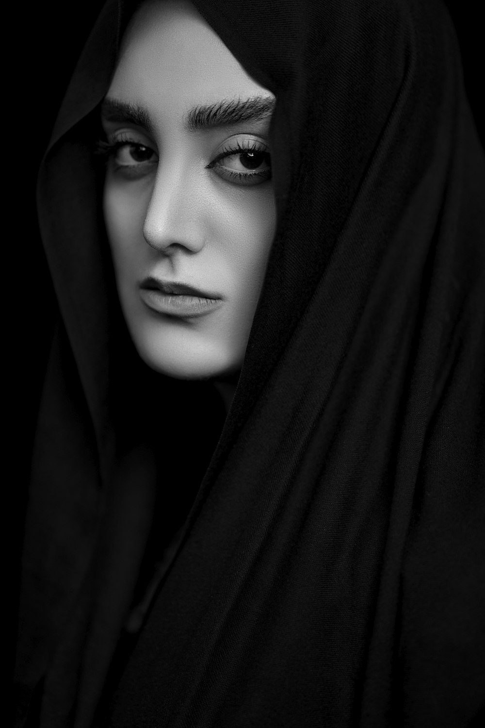 woman in black hijab in grayscale