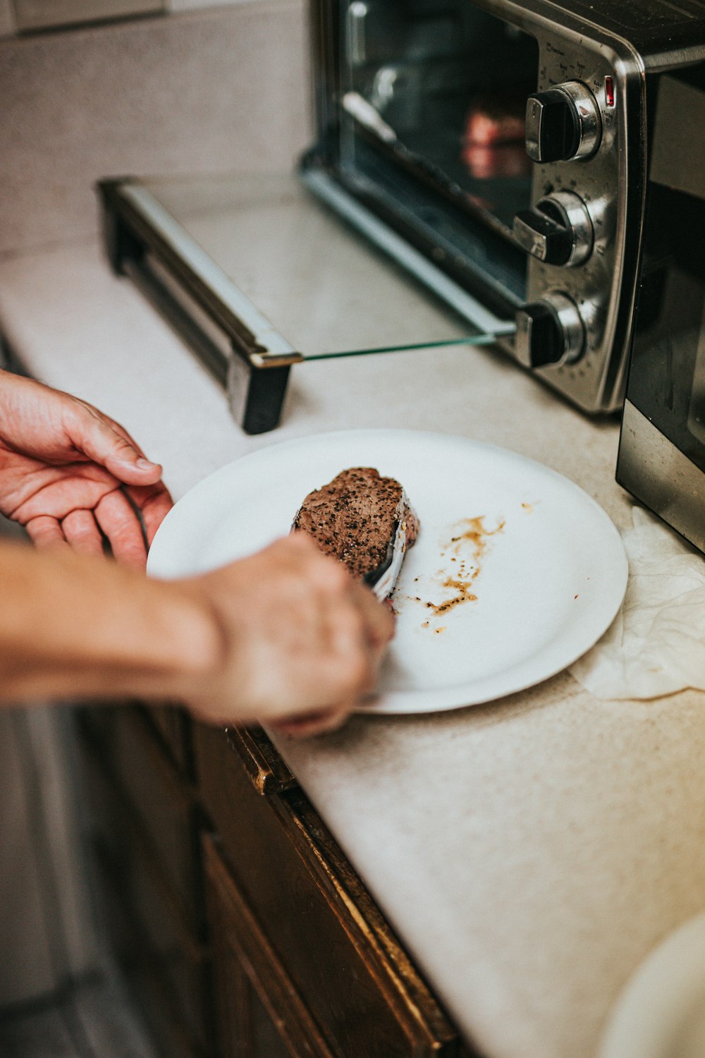 person holding white ceramic plate