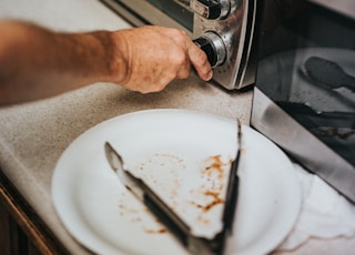 person holding stainless steel gas stove