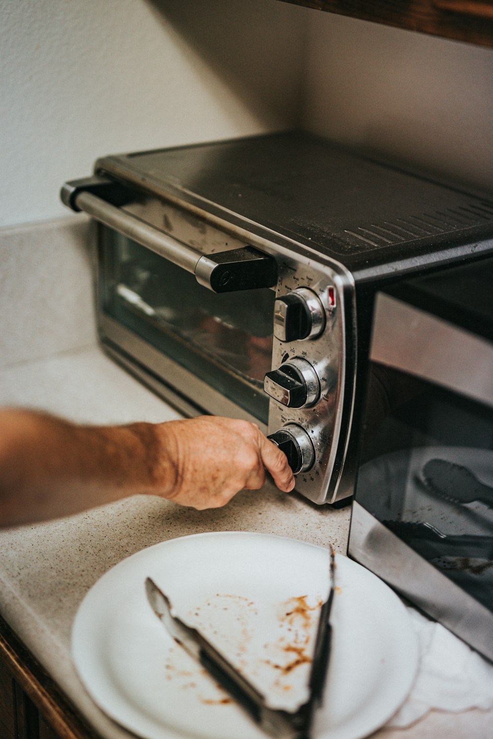 person holding stainless steel gas stove