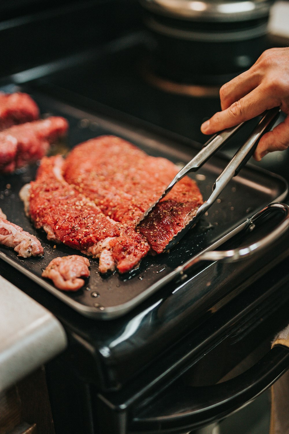 person holding stainless steel fork and steak knife