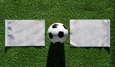 white soccer ball on green grass semi-abstract zoom background