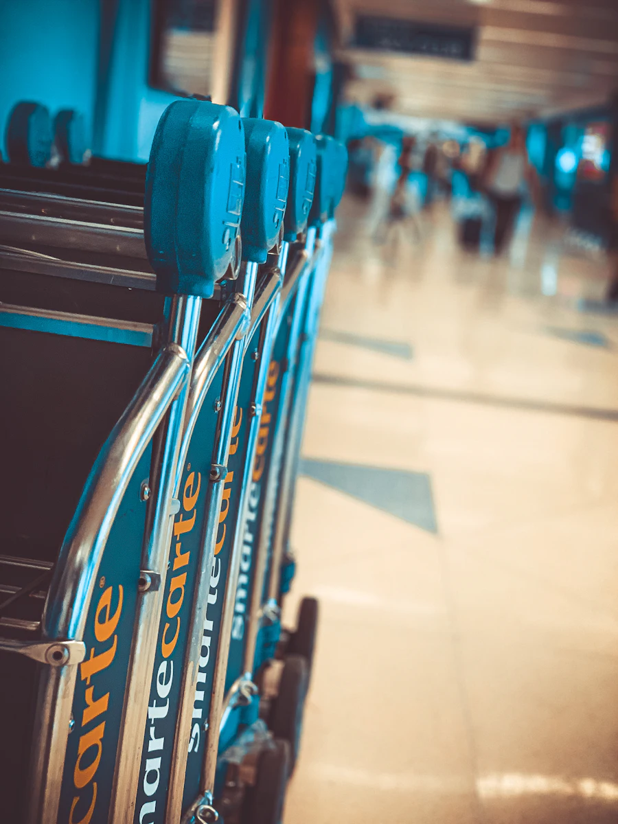 Airport wheelchairs and assistance equipment lined up in a terminal