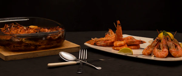 Grilled prawns with lemon on a dark platter
