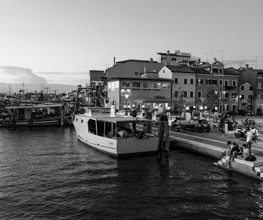 grayscale photo of boat on water in Chioggia Italy