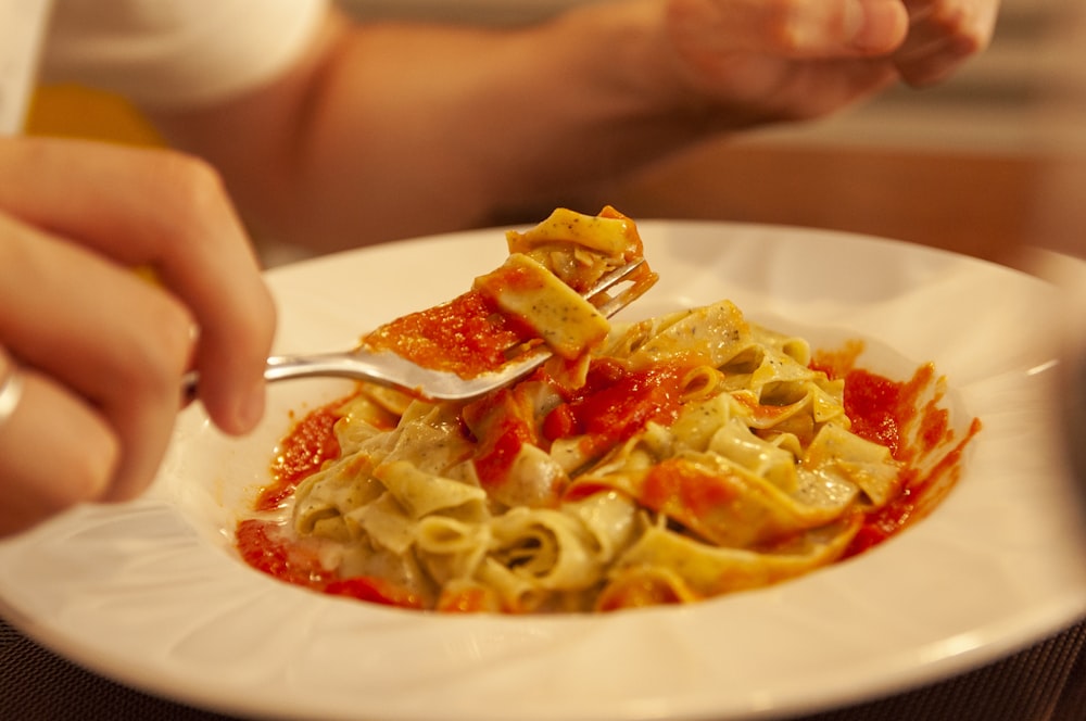 pasta with sauce on white ceramic plate