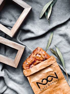 Elegant bakery paper bags with subtle logo printing, filled with fresh pastries.