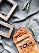 An inviting takeaway bag with the orobites logo, ready for a morning coffee and pastry to go.