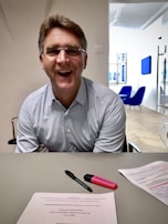 A smiling consultant assisting clients with their visa applications.