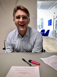 A smiling business owner reviewing sales reports with a satisfied expression.