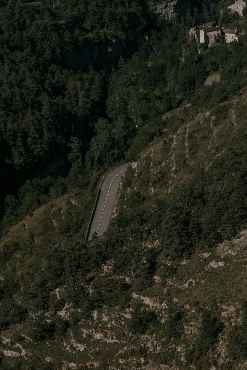 an aerial view of a winding road in the mountains