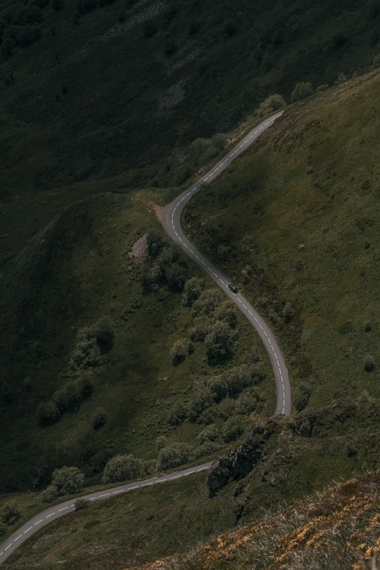 aerial view of road in the middle of green mountains in Puy Mary France