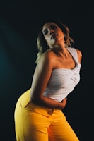 woman in white tank top and yellow pants
