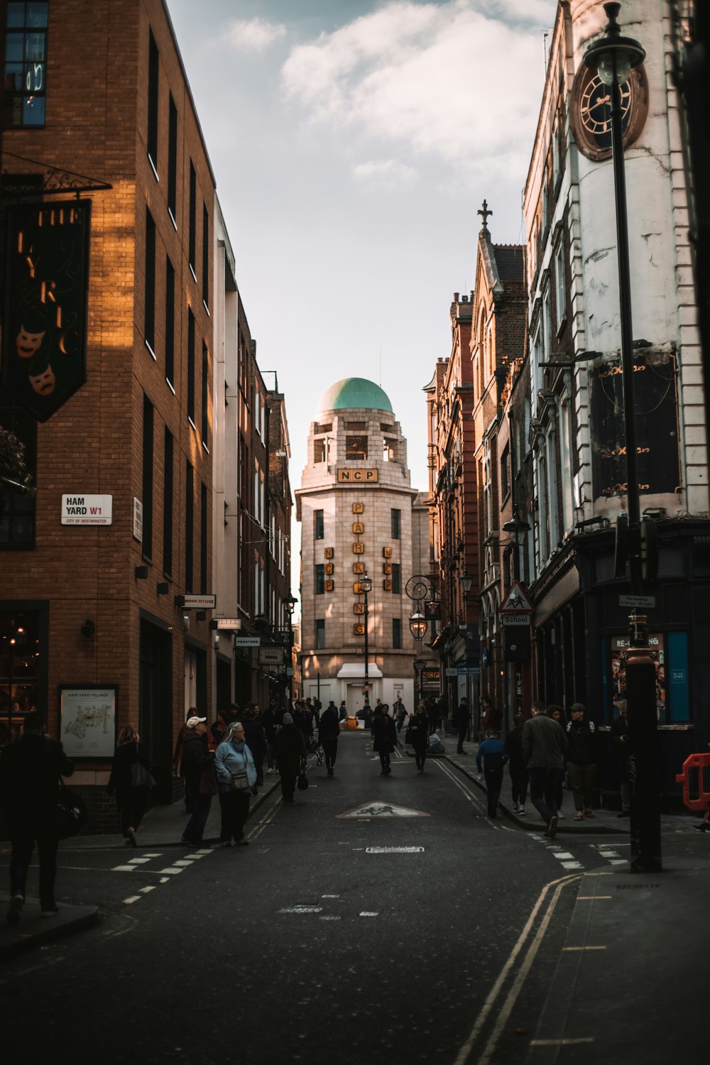 people walking on street near brown concrete building during daytime