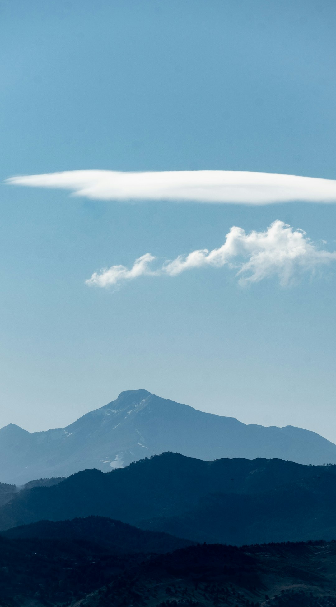 snow covered mountain under white clouds during daytime