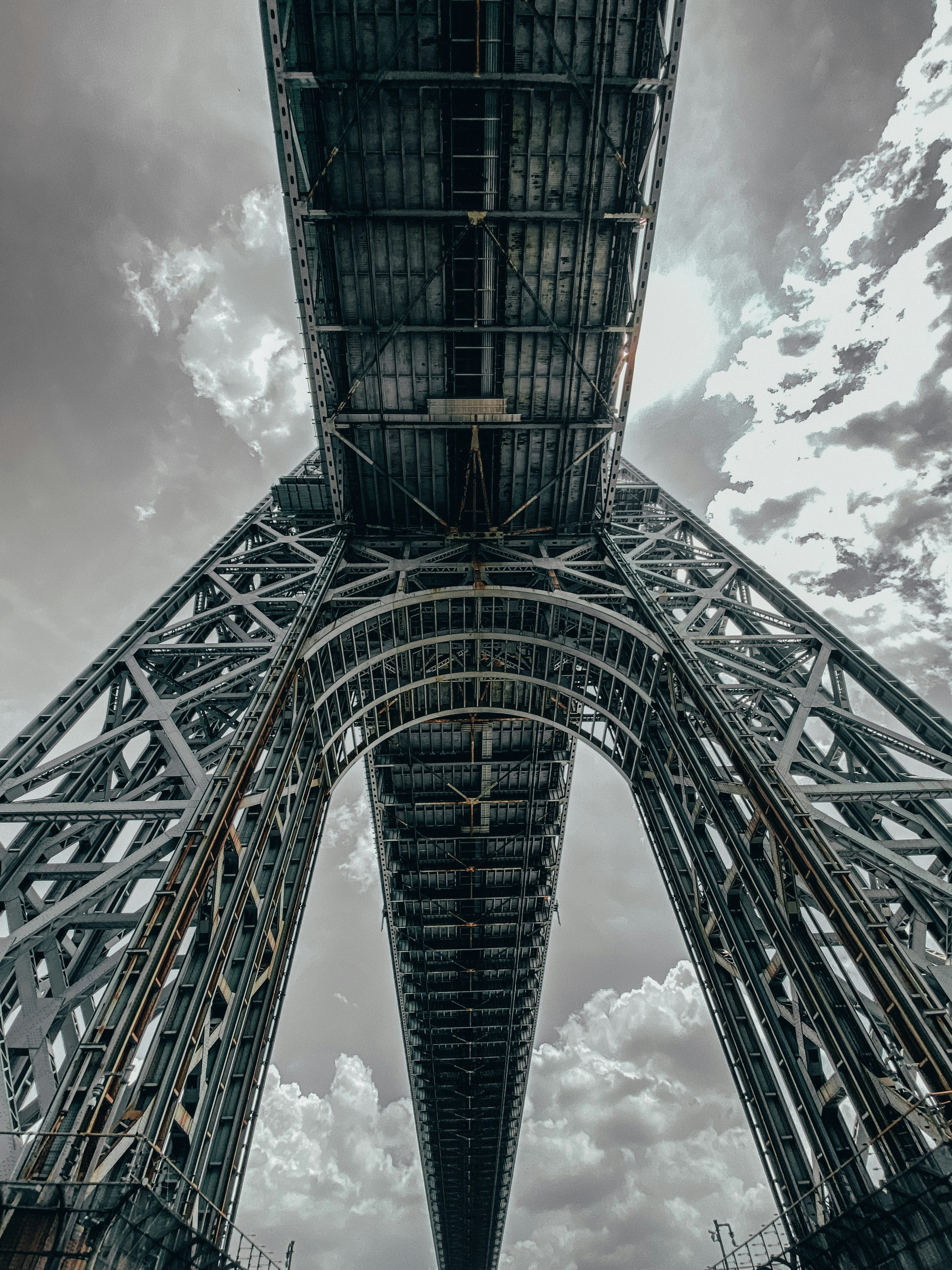 black metal tower under white clouds and blue sky during daytime