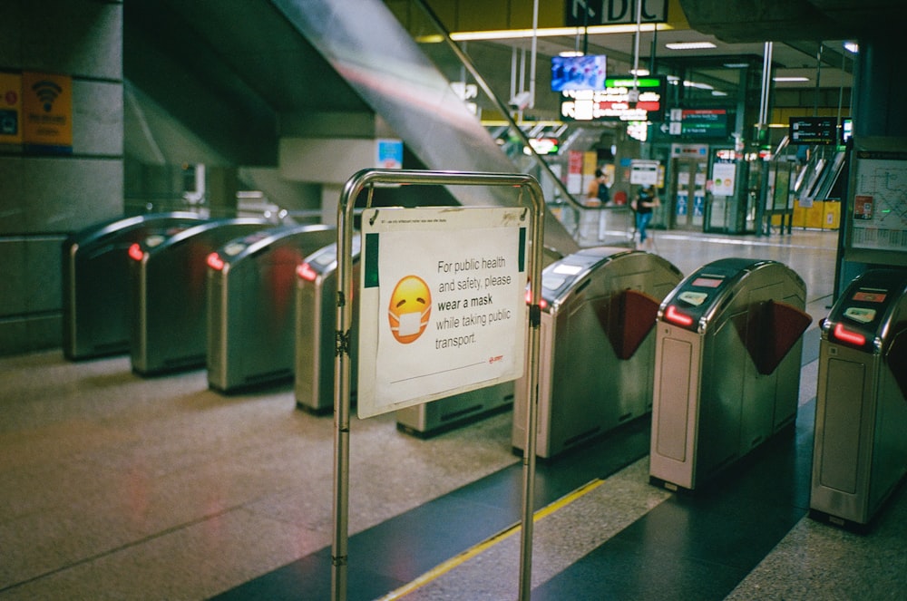 white and black signage on gray metal pole