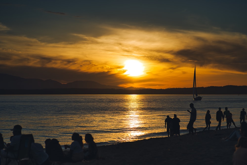 silhouette of people on beach during sunset