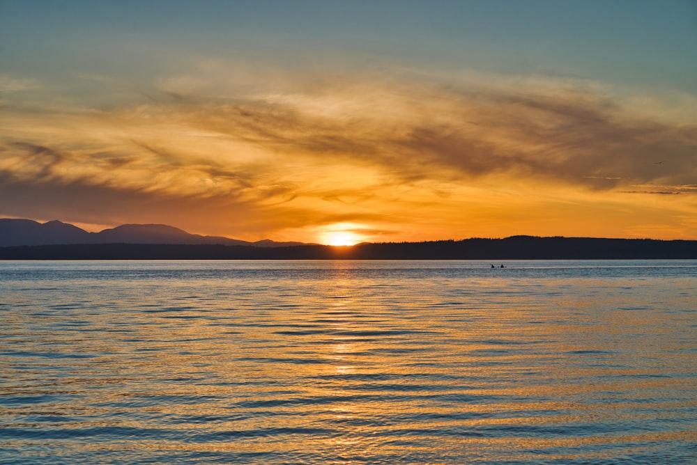 body of water during sunset