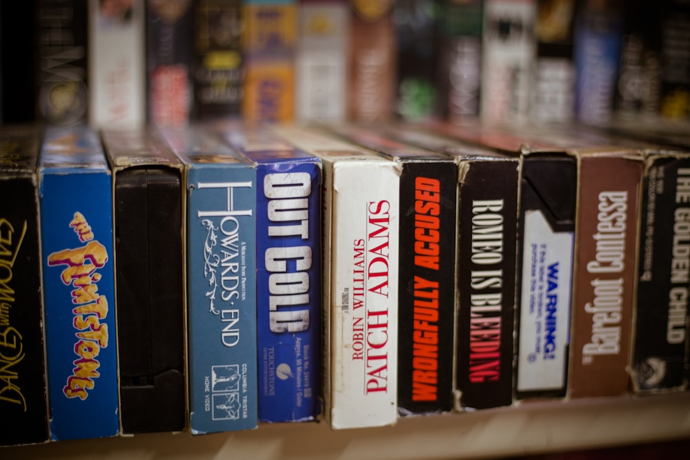 a row of books sitting on top of a shelf