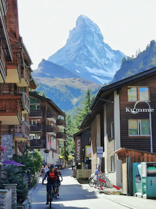 brown and white concrete buildings near mountain during daytime