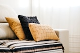 brown throw pillow on white and blue bed linen