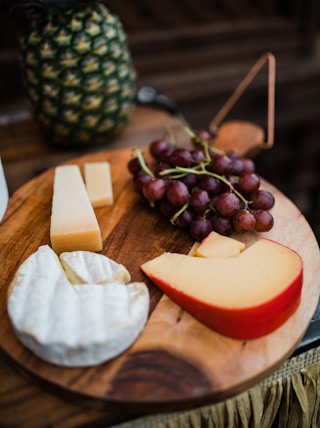 sliced cheese on brown wooden chopping board