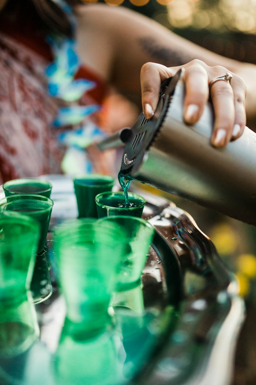 person holding green drinking glass