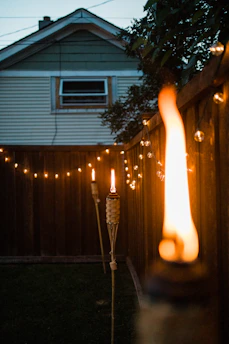 A cozy backyard lit by warm solar-powered lights at dusk.